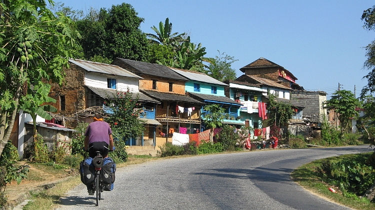 The Lonely Cyclist passing a village on the Prithivi Highway. Picture by Willem Hoffmans